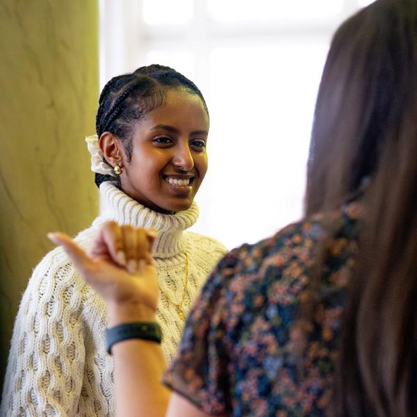 A female student speaking to a staff member.