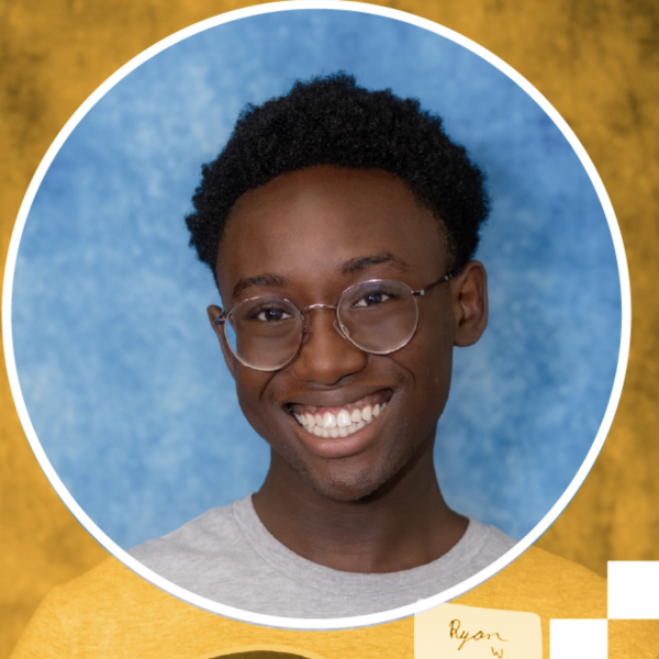 A photo of a student with short dark hair and glasses in a grey tshirt.