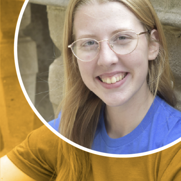 A woman with long blonde hair and glasses smiling.