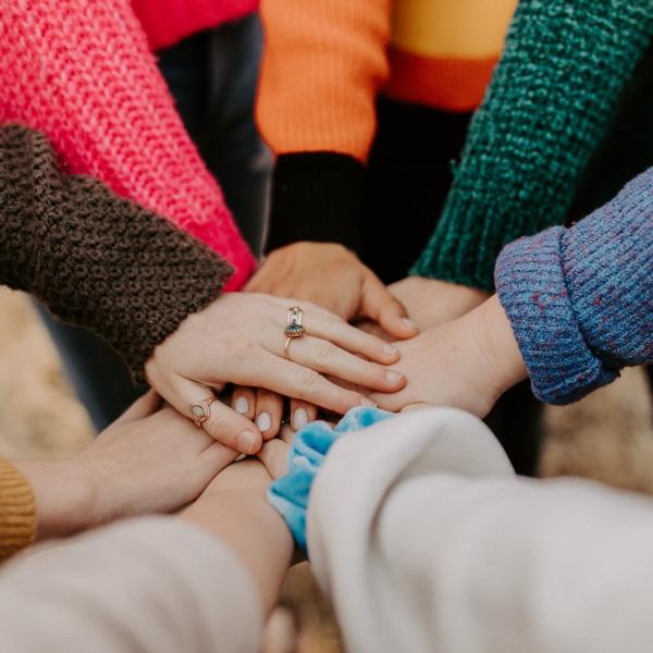 students with their hands together