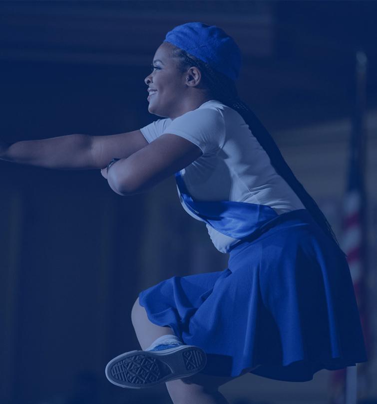 Student dancing on a stage.