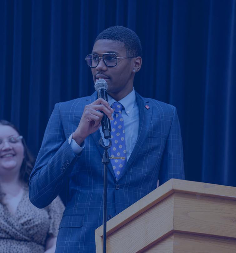 Student speaking at a podium.