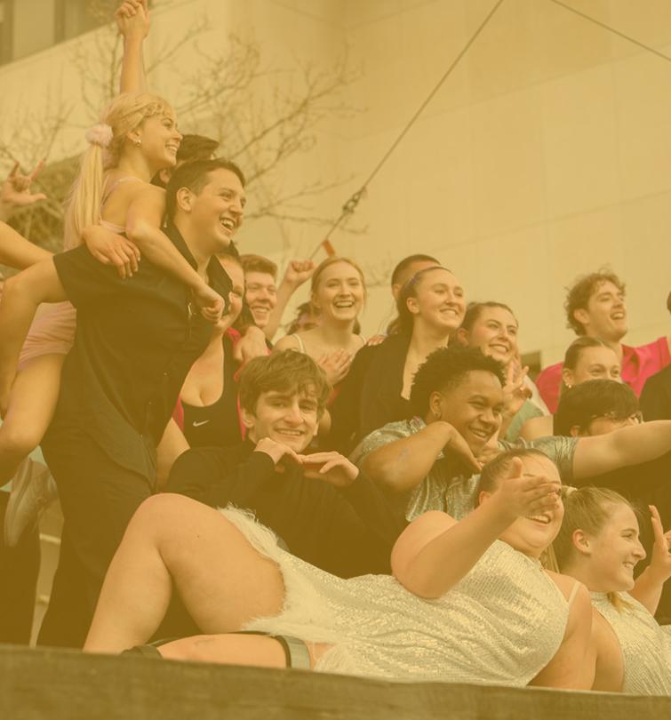 A group of students posing on a stage.