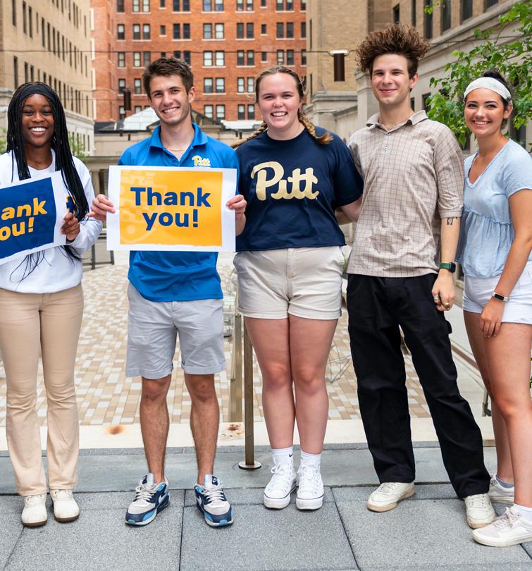 Students holding signs that say Thank You.