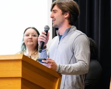 Student speaking at a podium