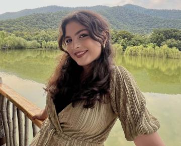 Young woman smiling outdoors.