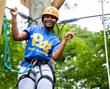 Person on a high ropes course.