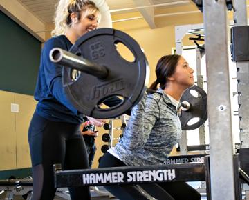 Women in gym lifting