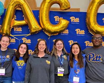 Students posing with ACC balloons.