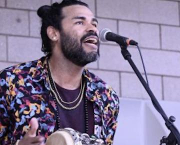 person playing an instrument and singing