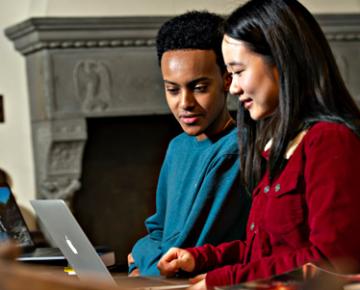 Two students working on laptops.