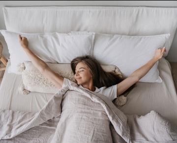 Woman stretching in bed