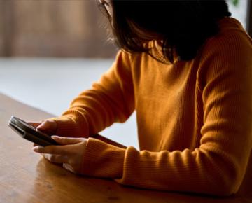 Student looking down at phone