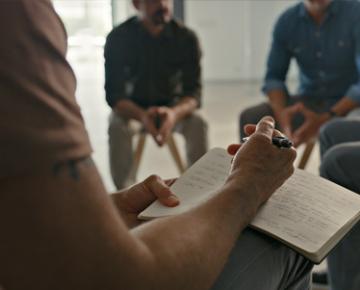 Person writing in notebook