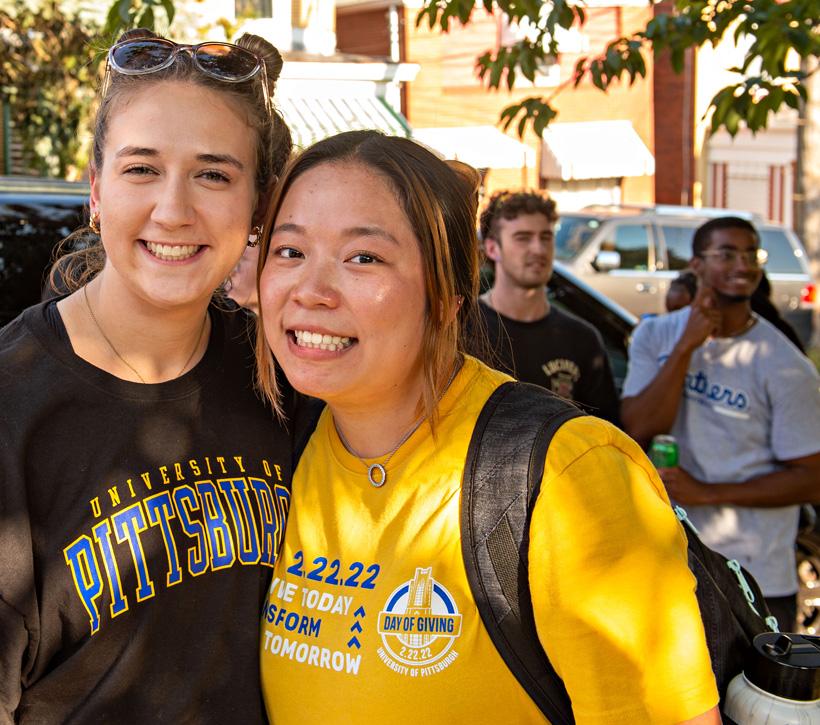 Students smiling outside on campus.