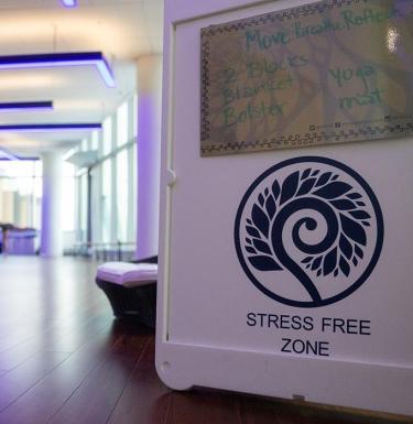 A sign that reads "Stress Free Zone" in front of an empty room.