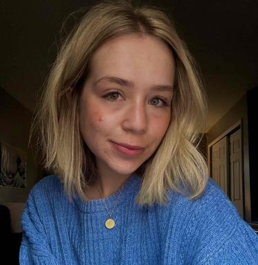 Young blonde woman in blue sweater