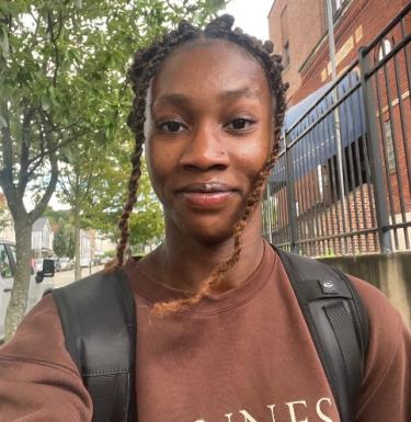 Woman in brown shirt outside