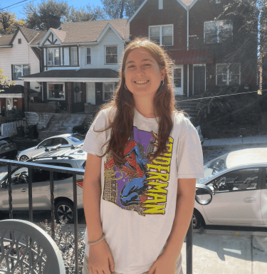 woman in white t-shirt smiling outdoors