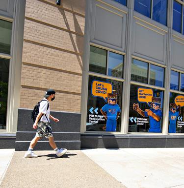 Student walking into Health Hub