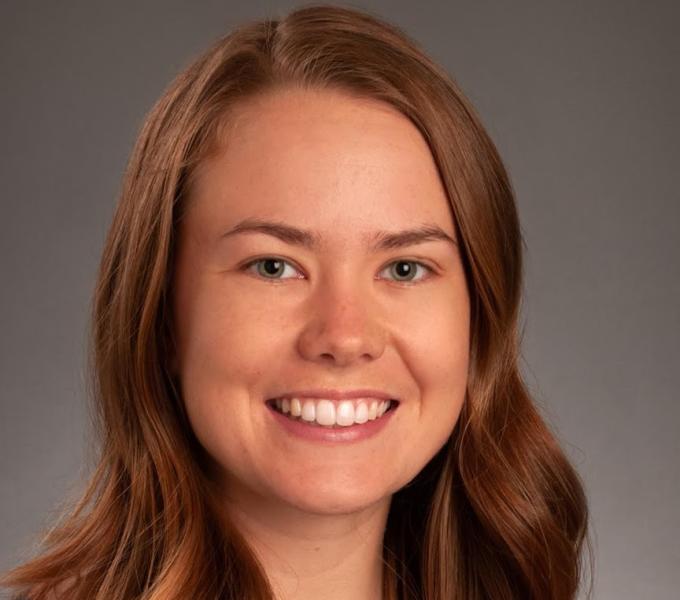 Woman smiling in front of backdrop